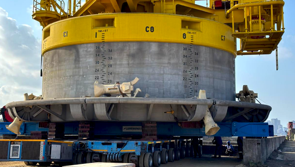 Large offshore structure being transported on self-propelled modular transporters.